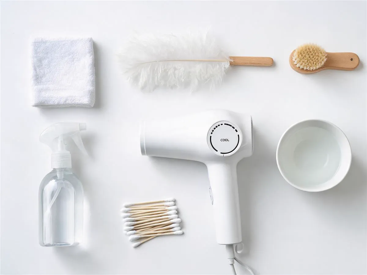 Silk flower cleaning supplies: microfiber cloth, feather duster, brush, spray bottle, hairdryer, cotton swabs