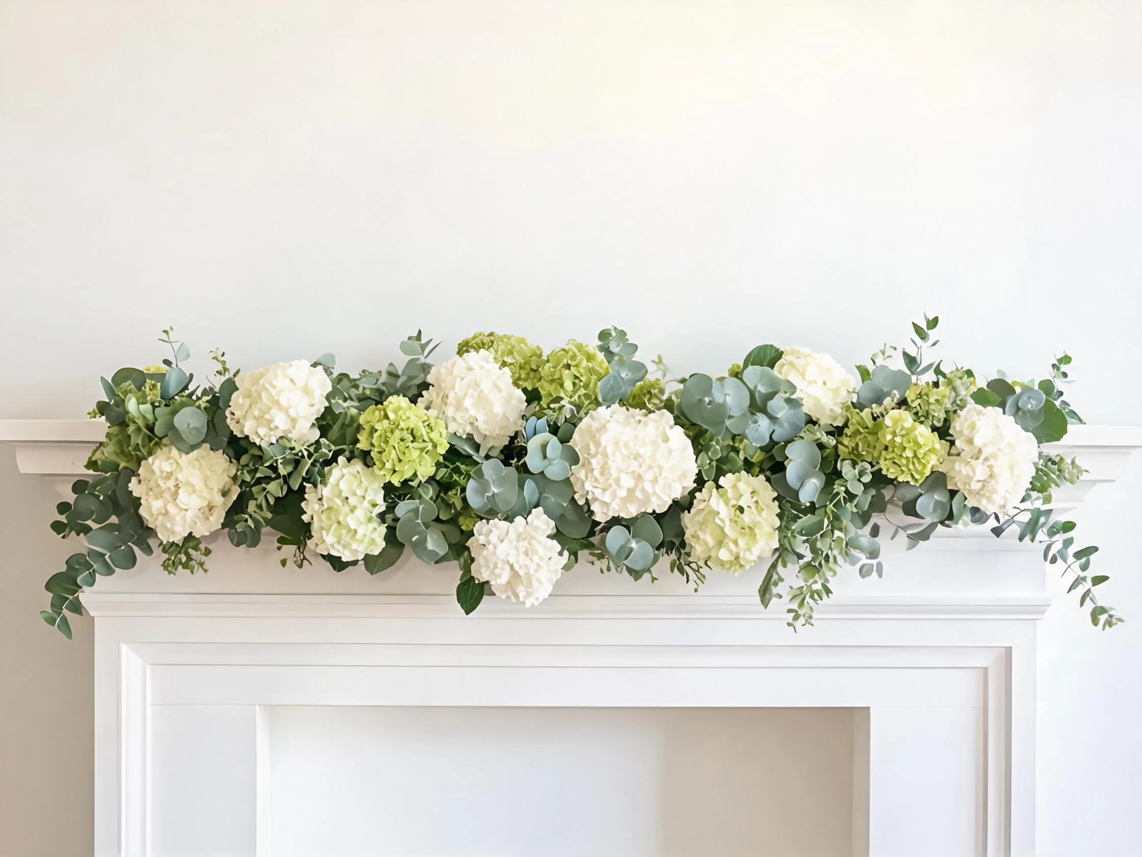 Artificial hydrangea garland on fireplace